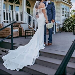 Form fitting. Small. Long train. Back detail. Off the shoulder. Wedding